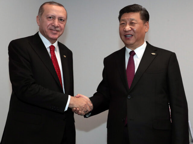 President of Turkey, Recep Tayyip Erdogan (L) and Chinese President Xi Jinping (R) shake h