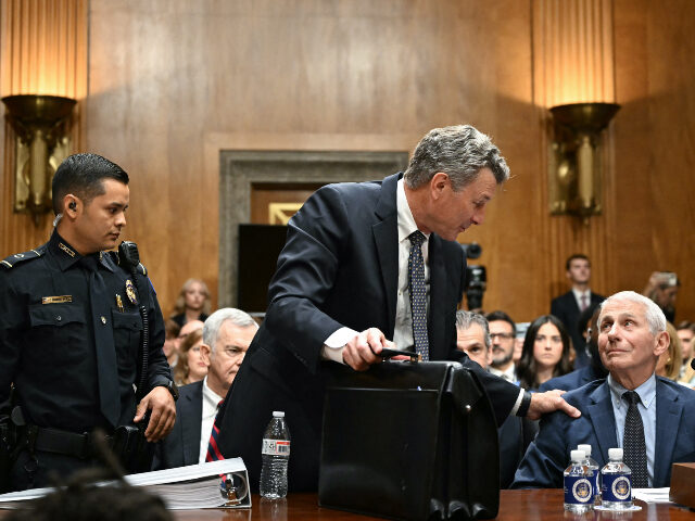 Dr. Anthony Fauci (R) looks on as his attorney David Schertler is asked to leave by a US C