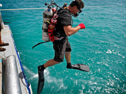Josh Fisher-Abt, grandson of Mel Fisher, steps off of the Dare to dive a newly created hol
