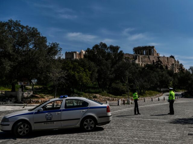 Police officers patrol near Acropolis hill in Athens on April 9, 2020 as Greek Police reco