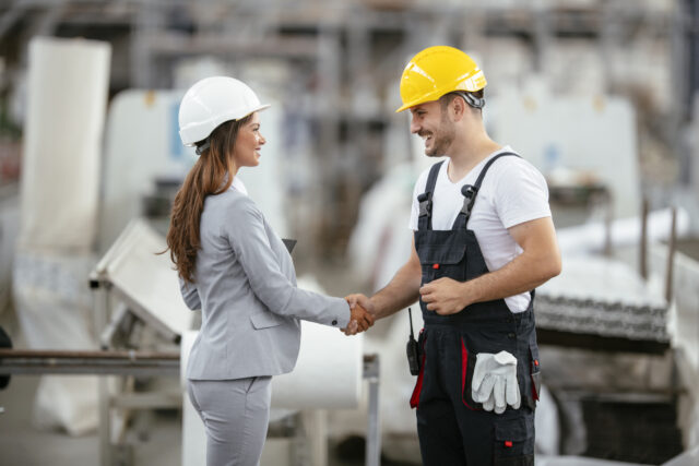 Factory worker and engineer doing inspection. Factory worker and businesswoman at producti