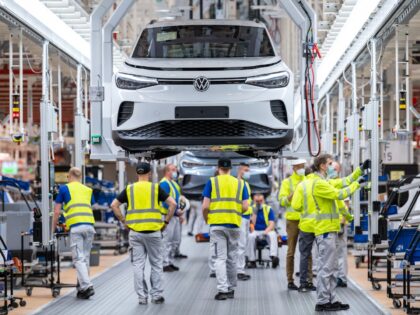 Employees work at the assembly line for the Volkswagen (VW) ID 4 electric car of German ca