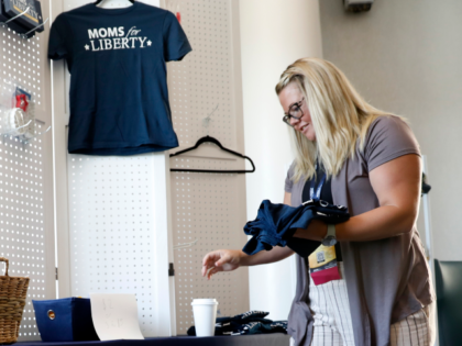 TAMPA, FL - JULY 15: Jara Jeffries of Iowa organizes Moms for Liberty apparel for sale in