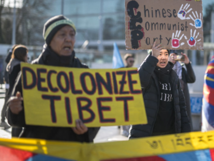 Tibetan activits stage a protest outside of the UN Offices at Geneva during the review of