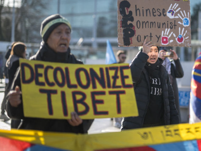 Tibetan activits stage a protest outside of the UN Offices at Geneva during the review of