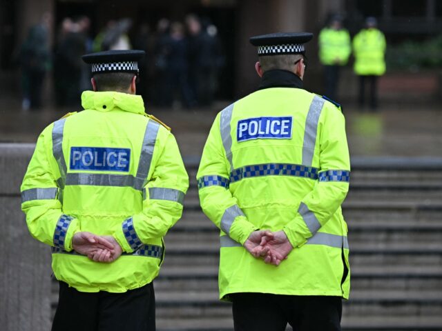 Police officers stand on duty outside The Queen Elizabeth II Law Courts in Liverpool, nort