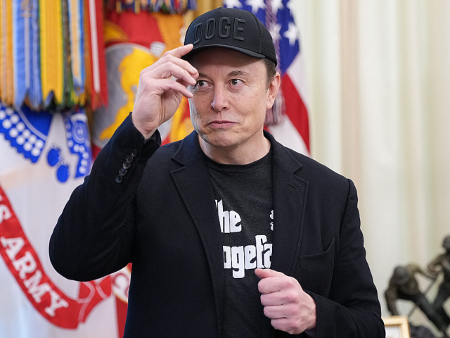 GettyImages-2217854100 WASHINGTON, DC - MAY 30: Tesla CEO Elon Musk removes his hat as he listens to a question f