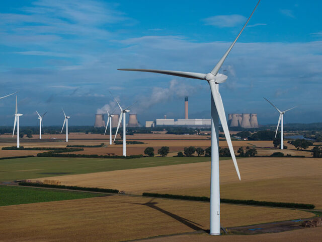 AIRMYN, ENGLAND - JULY 20: Wind turbines stand in front of Drax Power Station, operated by