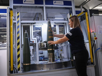 An employee works in the shell marking of 155mm artillery ammunition at Rheinmetall's