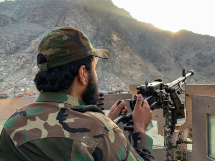 A Taliban security personnel stands guard near the Torkham border crossing between Afghani