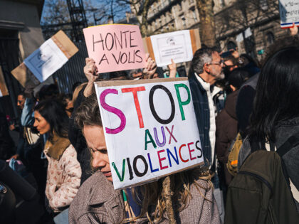 Mothers are holding up placards bearing the MeTooEcole logo, which depicts a crying child,