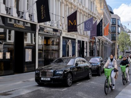 Two Rolls Royce cars parked outside exclusive shops on Bond Street on 5th April 2026 in Lo