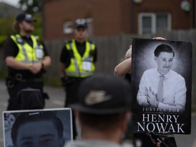 A protester holds an image of Henry Nowak outside Portswood Police station in Southampton,