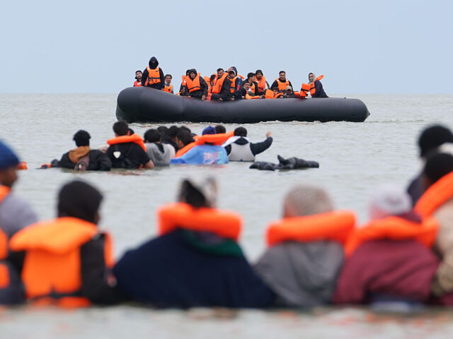 Migrant Channel crossing incidents People thought to be migrants wade in the water as they attempt to board a small boat off