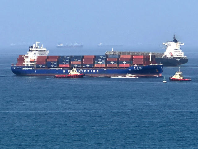 A cargo ship is pictured off coast of the Khor Fakkan Container Terminal, the only natural
