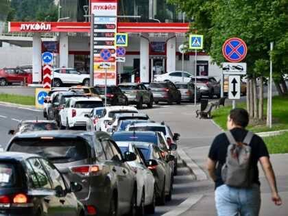 People queue to refuel their cars at a Lukoil petrol station in Moscow on June 30, 2026. R