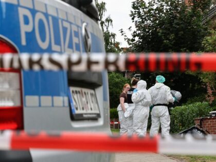 Forensic Police officers work at the scene where six people were killed in a shooting the