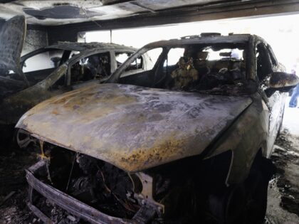 THESSALONIKI, GREECE - JULY 1: A view of burned vehicles on the roof of an apartment build