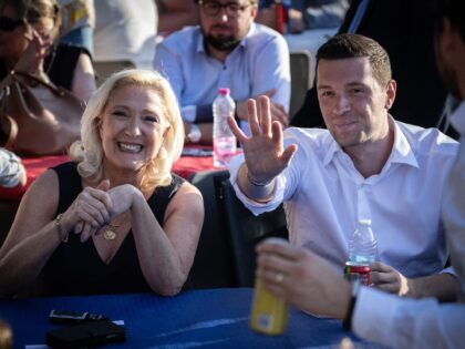 President of Rassemblement National parliamentary group Marine Le Pen (L) reacts next to F