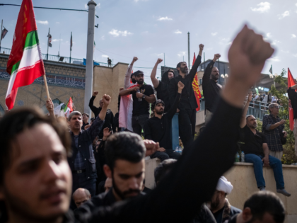 Iranian mourners shout slogans while taking part in a farewell ceremony for the bodies of