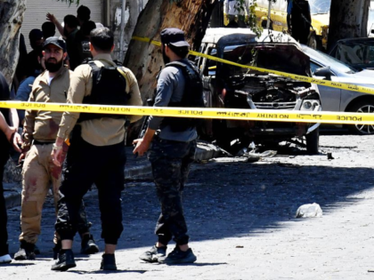 Security personnel cordon off the area around the blast site near the Ministry of Tourism