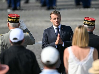 France's President Emmanuel Macron (C) gestures during the annual Bastille Day military pa