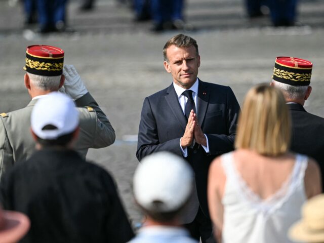 France's President Emmanuel Macron (C) gestures during the annual Bastille Day military pa