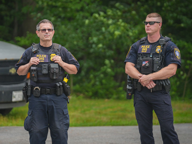 SCARBOROUGH, MAINE - JULY 14: Department of Homeland Security (DHS) officers stand guard o