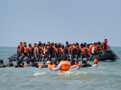 People thought to be migrants board a small boat off the coast of Equihen-Plage, France, d