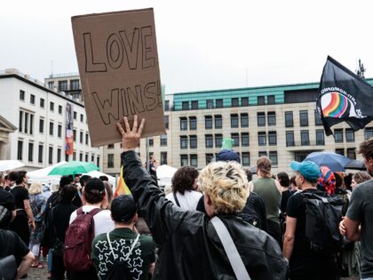 BERLIN, GERMANY - 2026/07/26: A person holds a "Love wins" placard during a memorial rally