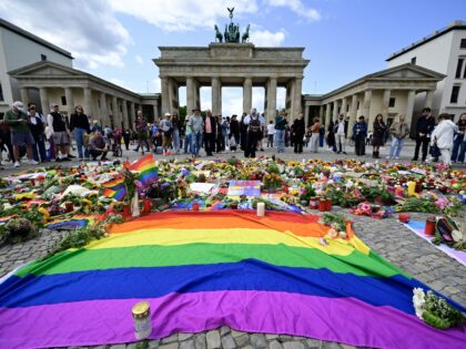 TOPSHOT - People pay their respects in front of landmark Brandenburg Gate where flowers, c