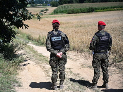 Police officers of the "Military Gendarmerie" stand guard in an area near the vi