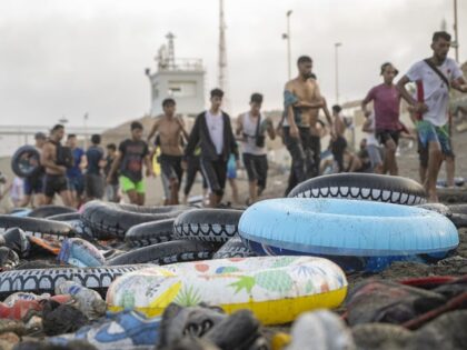 Hundreds of migrants have attempted to swim from Morocco to the Spanish city of Ceuta in N