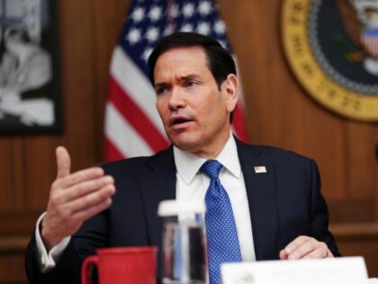 US Secretary of State Marco Rubio speaks as President Donald Trump looks on during a Cabin