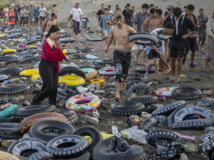 Boat people and migrants after crossing the border between Ceuta and Morocco, on 31 July,