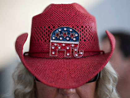 Karina Hollands wears her "liberal repellant hat" while waiting to enter an event with Ric