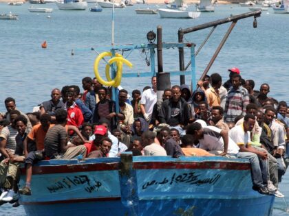 Would-be immigrants arrive on a boat in the port of Italy's southern island of Lampedusa l