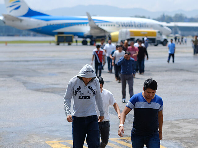 Guatemalans walk off a plane during the arrival of a flight coming from Mesa, Arizona with