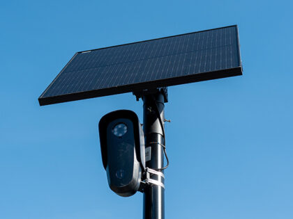 Flock license plate reader and camera with solar panel against a blue sky, Pleasant Hill,