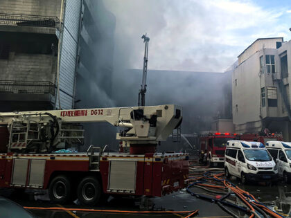Firefighters work after a fire broke out at a shoe factory in Jiangtou Village, Chendai To