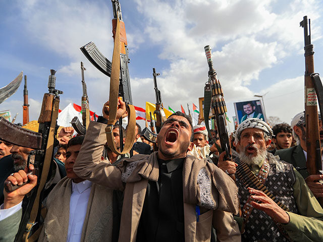 Armed Yemeni supporters of the Iran-backed Houthi movement brandish their weapons during a