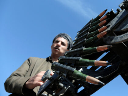 A Houthi fighter manning a machine gun mounted on a vehicle during a tribal parade held ag