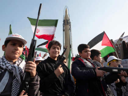 Iranian schoolboys, as members of the Basij paramilitary force under the command of the Is