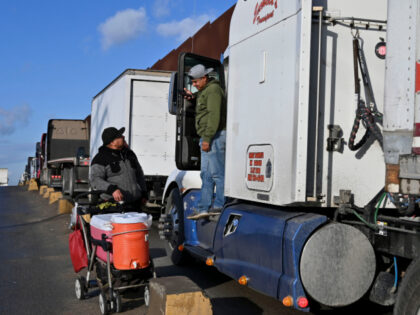 A vendor sells drinks to truck drivers as they wait in line at the Otay Mesa Port of Entry