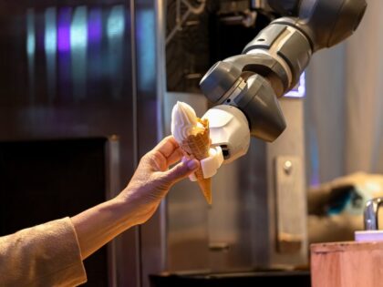 Robot handing ice cream cone to human