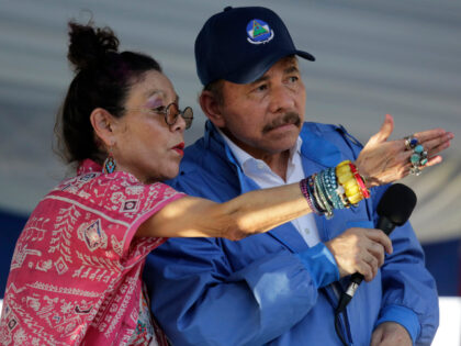 Nicaraguan Vice President Rosario Murillo (L) gestures next to her husband Nicaraguan Pres