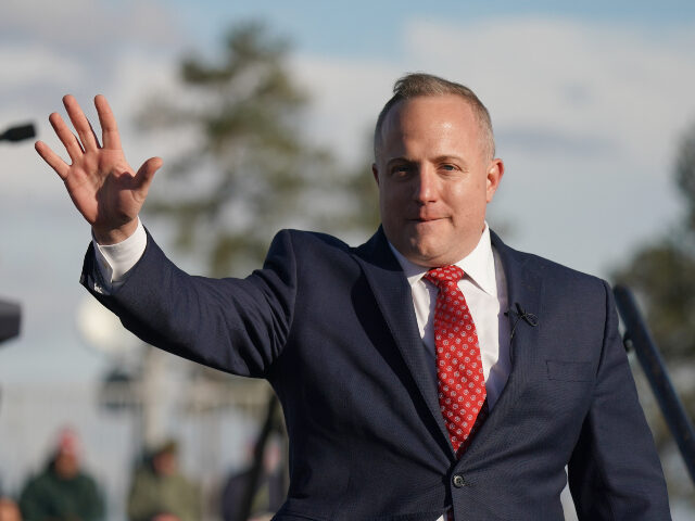 House of Representatives candidate Russell Fry waves to a crowd during a rally with former