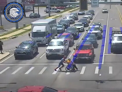 Spiderman helps wheelchair-bound man across busy street