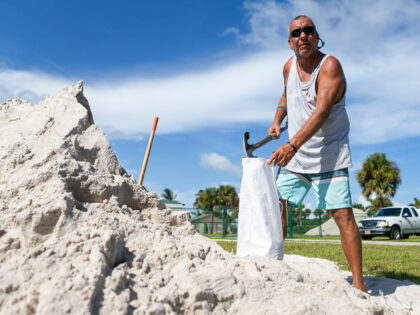 Danny Marcello, of Fort Pierce, Fla., loads bags of sand in preparation for Hurricane Dori