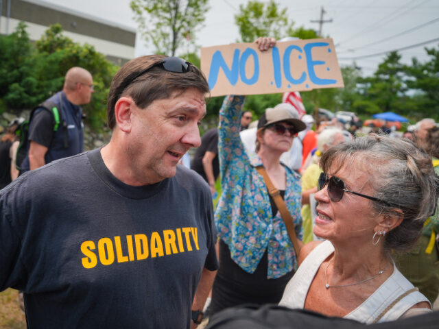 Troy Jackson, Woman Troy Jackson, Democratic candidate for U.S. Senate, speaks to a woman during a demonstrati
